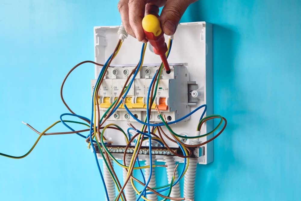 Professional Hot Shot Electric certified electrician upgrading breaker box – licensed Tulsa experts fix tripped breakers and install modern panels for safe home power.