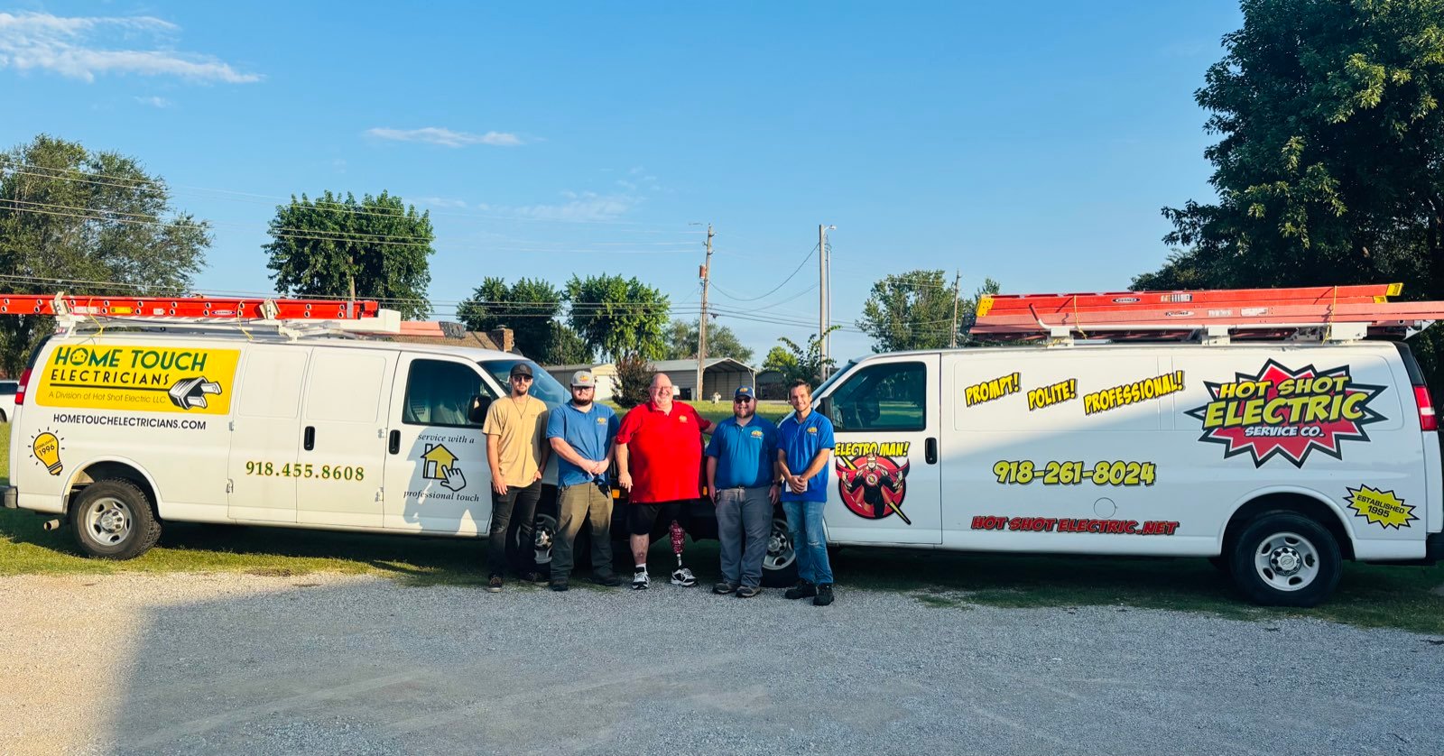 The Hot Shot Electrical team standing between the Home Touch Electricians van and the Hot Shot Electric van in Broken Arrow, Oklahoma
